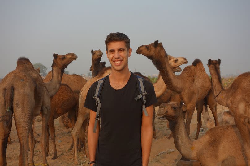 Josh Gluckstein pictured with camels in India 