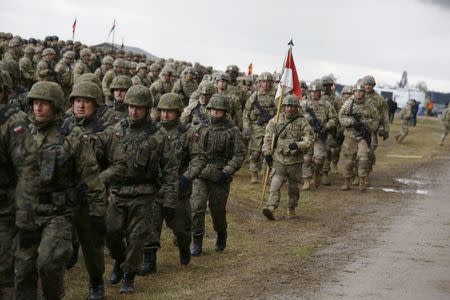 Polish and U.S. soldiers attend welcoming ceremony for U.S.-led NATO troops at polygon near Orzysz, Poland, April 13, 2017. REUTERS/Kacper Pempel