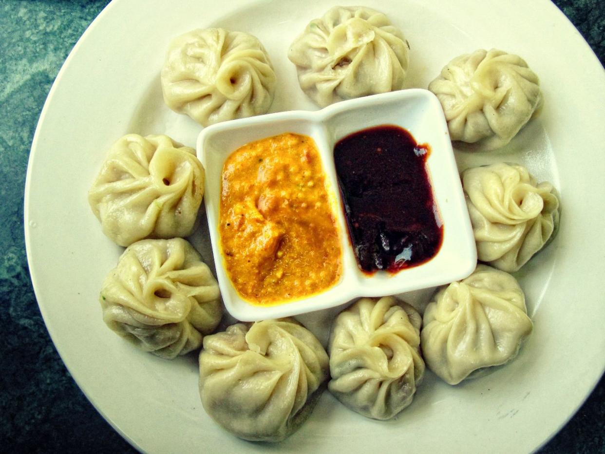A typical serving of a plate of Momo with Sesame Yellow Sauce and Red Ginger Chilli Sauce in Nepal