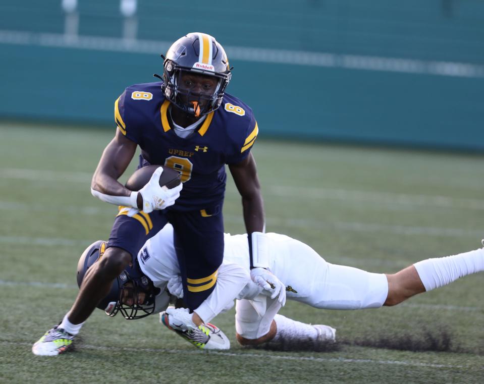 UPrep Tyrell Simmons is brought down by Victor High Alan Miller during first quarter action at Rochester Community Sports Complex in Rochester, NY on September 2, 2022.