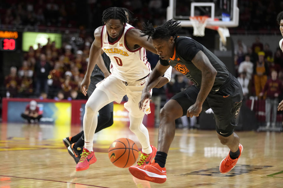 Iowa State forward Tre King (0) fights for a loose ball with Oklahoma State guard Quion Williams (5) during the second half of an NCAA college basketball game, Saturday, Jan. 13, 2024, in Ames, Iowa. (AP Photo/Charlie Neibergall)