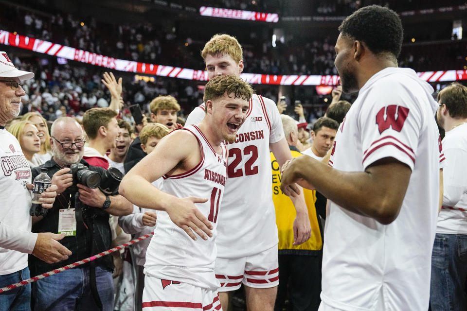 Wisconsin's Max Klesmit (11) and Steven Crowl (22) celebrate after Wisconsin defeated No. 3 Marquette in an NCAA college basketball game Saturday, Dec. 2, 2023, in Madison, Wis. (AP Photo/Andy Manis)