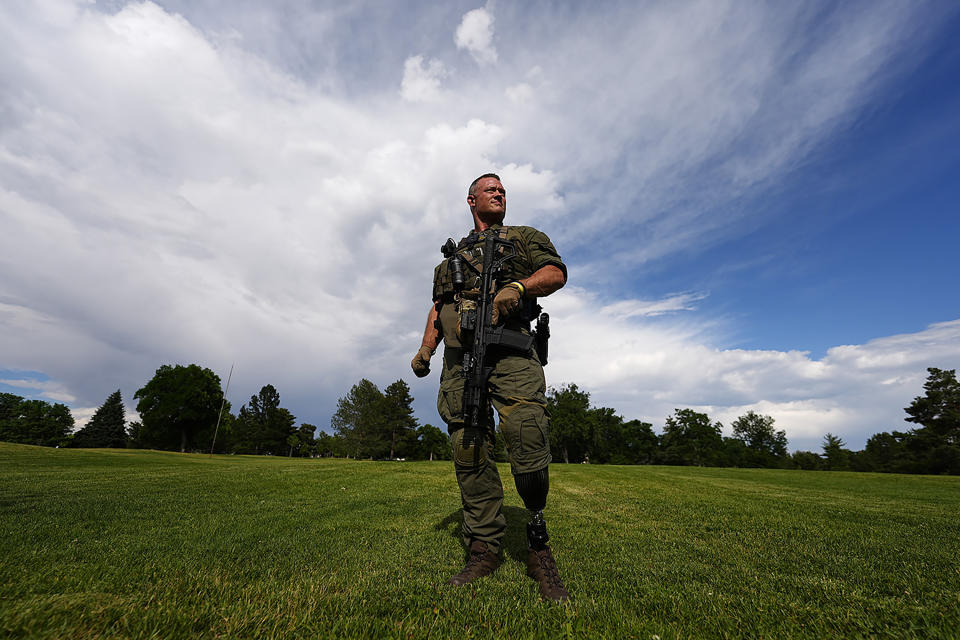 Denver Police Department Sgt. Justin Dodge stands for a portrait Wednesday, June 12, 2024, in south Denver. Dodge lost his left leg below the knee when he was struck by a firetruck carrying members of the NBA champion Denver Nuggets as the officer was providing security along the parade route for winning the title last June. (AP Photo/David Zalubowski)