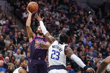 Jan 11, 2019; Minneapolis, MN, USA; Minnesota Timberwolves guard Derrick Rose (25) shoots over Dallas Mavericks guard Wesley Matthews (23) during the third quarter at Target Center. Mandatory Credit: Brace Hemmelgarn-USA TODAY Sports