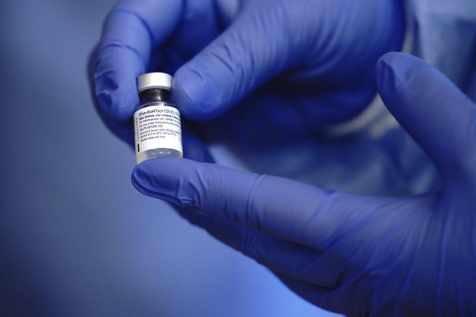 A member of the vaccination team at a nursing home holds a dose of the Covid-19 vaccine in Berlin, Germany, on Sunday, Dec. 27, 2020. The first shipments of coronavirus vaccines developed by BioNTech and Pfizer have arrived across the European Union, authorities started to vaccinate the most vulnerable people in a coordinated effort on Sunday. (Kay Nietfeld/Pool via AP)