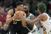 Milwaukee Bucks forward Giannis Antetokounmpo (34) grapples with Boston Celtics guard Jaylen Brown, behind center, and guard Marcus Smart, right, during the second half of Game 7 of an NBA basketball Eastern Conference semifinals playoff series, Sunday, May 15, 2022, in Boston. (AP Photo/Steven Senne)