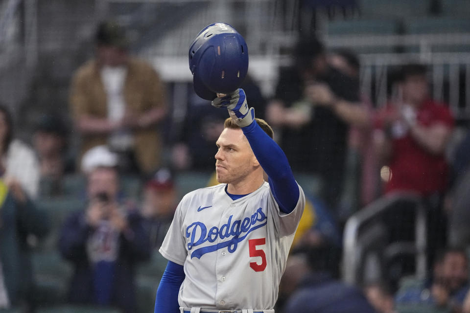 Los Angeles Dodgers first baseman and former Atlanta Brave Freddie Freeman tips his helmet to the crowd as he steps to the plate to bat in the first inning of a baseball game against the Atlanta Braves, Monday, May 22, 2023, in Atlanta. (AP Photo/John Bazemore)