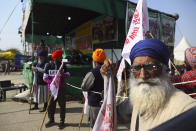 Indian farmer volunteers managing the stage keep guard at Singhu, the Delhi-Haryana border camp for protesting farmers against three farm bills, in New Delhi, India, Wednesday, Jan. 27, 2021. Leaders of a protest movement sought Wednesday to distance themselves from a day of violence when thousands of farmers stormed India's historic Red Fort, the most dramatic moment in two months of demonstrations that have grown into a major challenge of Prime Minister Narendra Modi’s government. (AP Photo/Manish Swarup)