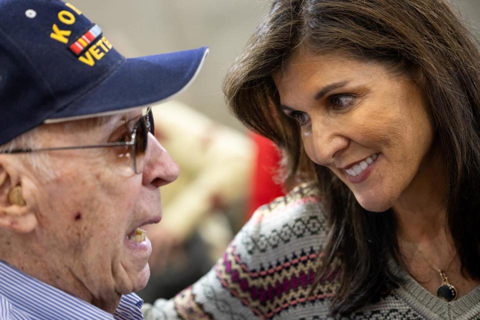 Nikki Haley speaks to a veteran wearing a cap