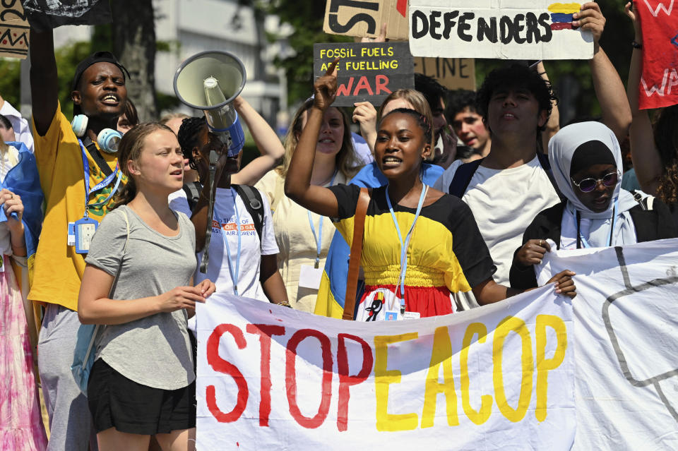 Patience Nabukalu, climate activist from Uganda, front center, and Greta Thunberg, front left, attend a Fridays for Future protest rally in Bonn, Germany, Monday, June 12, 2023 against a planned oil pipeline in East Africa. The project, which has been criticized by climate change activists, would see oil transported in a new 1443 kilometer (896 miles) long pipeline from western Uganda through Tanzania to the Indian Ocean. (Henning Kaiser/dpa via AP)