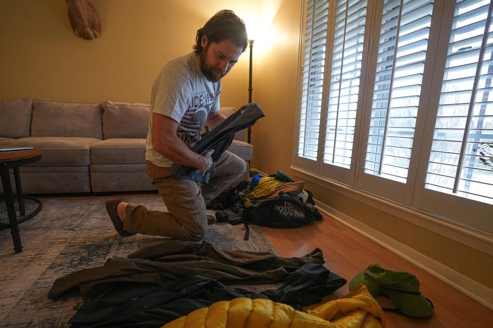 Southwestern University's Branndon Bargo packs his travel bag in his West Austin home as he prepares to take 12 students to Africa to summit Mount Kilimanjaro in January.