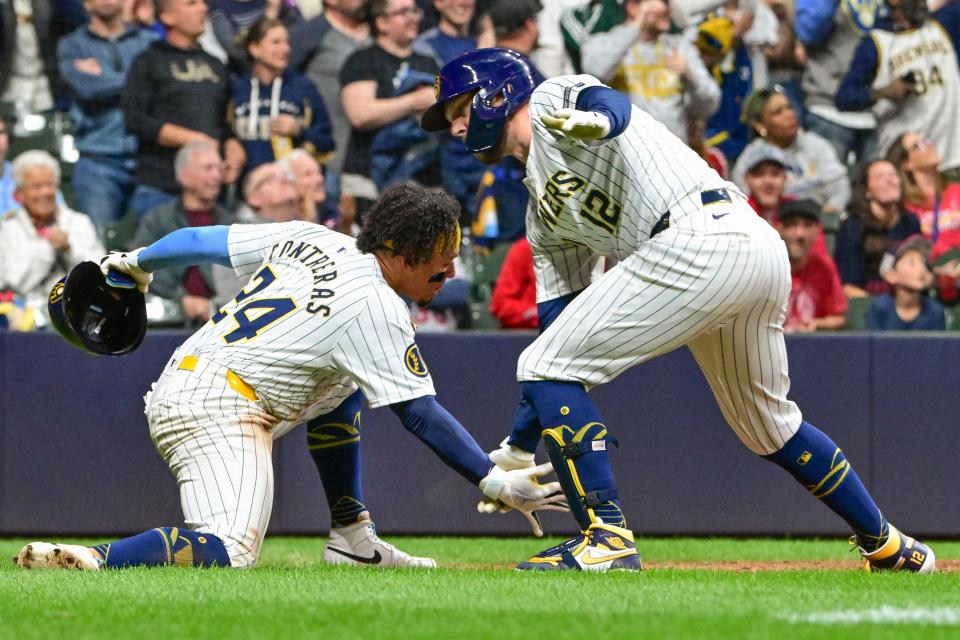 Brewers first baseman Rhys Hoskins celebrates with catcher William Contreras (24) after hitting a three-run home run in the seventh inning Saturday night at American Family Field.