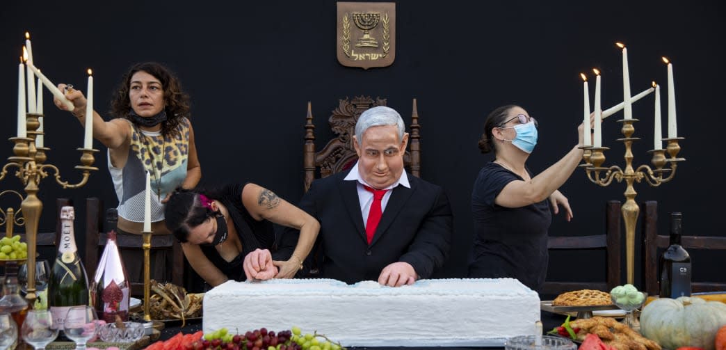 Team members of Israeli artist Itay Zalait work on an installation depicting Prime Minister Benjamin Netanyahu at a mock 