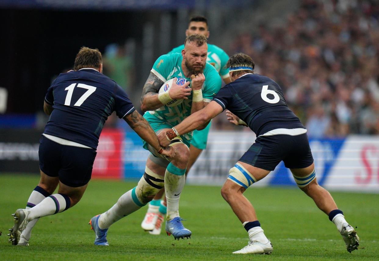 South Africa's Rg Snyman, enter, tries to break through from Scotland's Jamie Bhatti (AP)