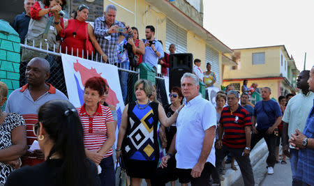 FILE PHOTO: Cuba's First Vice-President Miguel Diaz-Canel stands in line with his wife Lis Cuesta and local residents before casting his vote during an election of candidates for the national and provincial assemblies, in Santa Clara, Cuba, March 11, 2018. Photo taken on March 11, 2018. REUTERS/Alejandro Ernesto/Pool/File Photo