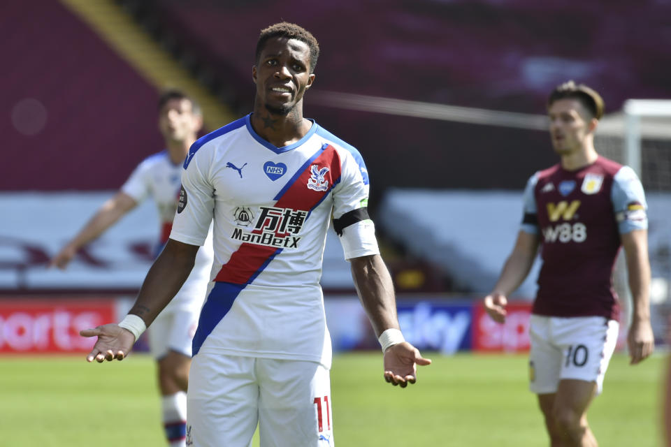 Crystal Palace's Wilfried Zaha reacts during the English Premier League soccer match between Aston Villa and Crystal Palace at Villa Park in Birmingham, England, Sunday, July 12, 2020. (AP Photo/Rui Viera, Pool)