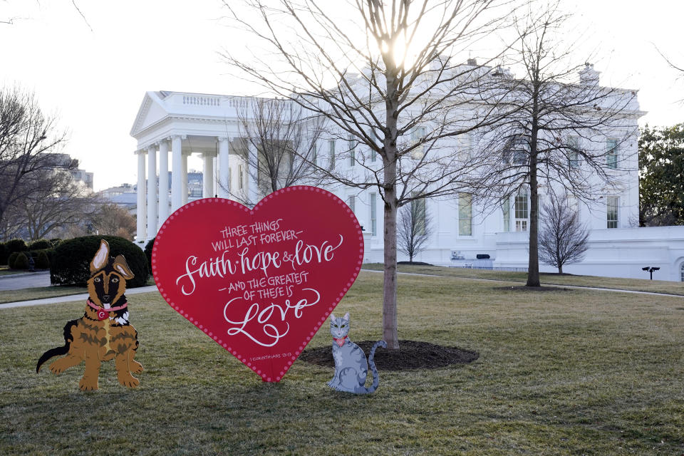 A Valentine's heart and depictions of President Joe Biden and first lady Jill Biden's pet dog Commander, left, and cat Willow, stand on the North Lawn of the White House in celebration of Valentine's Day, Monday, Feb. 14, 2022, in Washington. (AP Photo/Patrick Semansky)