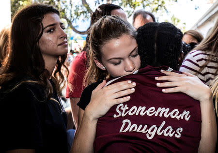 FILE PHOTO: Students from Marjory Stoneman Douglas High School attend a memorial following a school shooting incident in Parkland, Florida, U.S., February 15, 2018. REUTERS/Thom Baur/File Photo