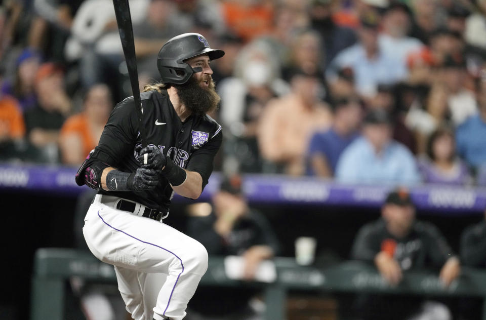 Colorado Rockies' Charlie Blackmon singles against San Francisco Giants starting pitcher Anthony DeSclafani in the third inning of a baseball game Saturday, Sept. 25, 2021, in Denver. (AP Photo/David Zalubowski)