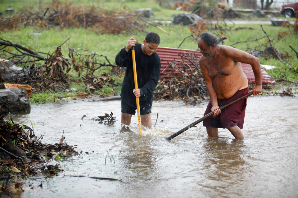 Residents of St. Croix work in floodwaters to clear a drain blocked by debris from Hurricane Maria as the island receives torrential rains on Sept. 30, 2017. (Photo: Jonathan Drake / Reuters)