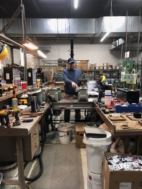 Dominion meter technician Josh Haskett explains a meter testing process to Grier Middle School students March 6, 2024.