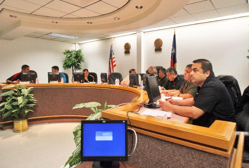 In a Saturday, Jan. 11, 2014 photo, La Villa Independent School District board members meet before going into executive session in La Villa, Texas. The City of La Villa turned off the school districts water at their four campuses over the winter break after the water bill went unpaid. Classes that were to resume on Monday have been canceled until Wednesday as the water rate is negotiated. (AP Photo/Joel Martinez/The Monitor)