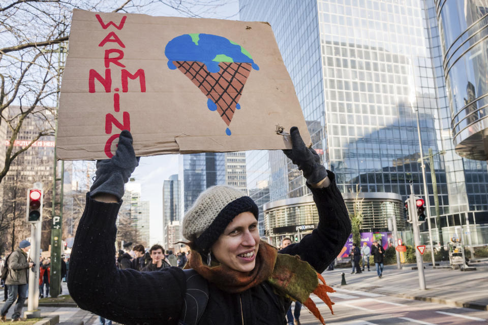 A student holds up a banner during a climate change protest in Brussels, Thursday, Feb. 14, 2019. Thousands of teenagers in Belgium have skipped school for the sith week in a row in an attempt to push authorities into providing better protection for the world's climate. (AP Photo/Geert Vanden Wijngaert)