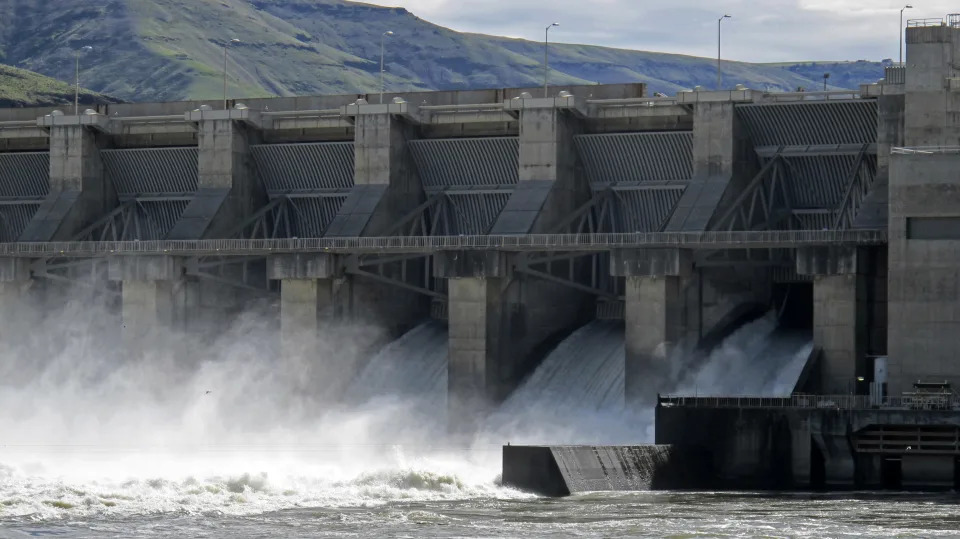 FILE - Water moves through a spillway of the Lower Granite Dam on the Snake River near Almota, Wash., on April 11, 2018. In the clearest sign yet that the U.S. will consider breaching four controversial dams on the Snake River to help salmon, a leaked administration document says the government is prepared to help build clean energy projects that would replace the power currently generated by the dams. (AP Photo/Nicholas K. Geranios, File)