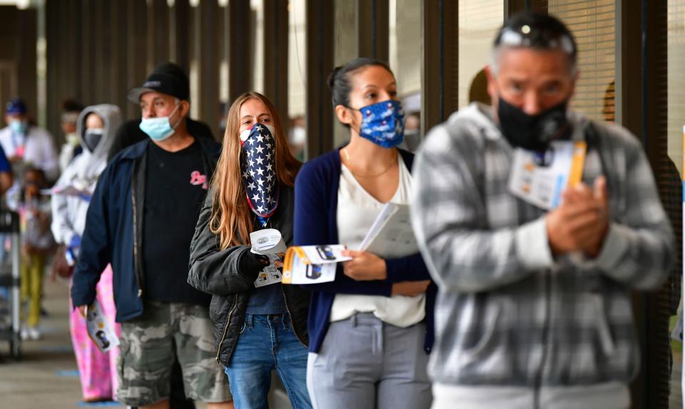 Voters wear face-coverings while waiting in line to vote for the 2020 US elections at the Los Angeles County Registrar in Norwalk, California. Photo: Frederic J Brown/AFP/Getty