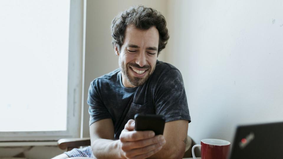 man smiling while messaging woman on dating app