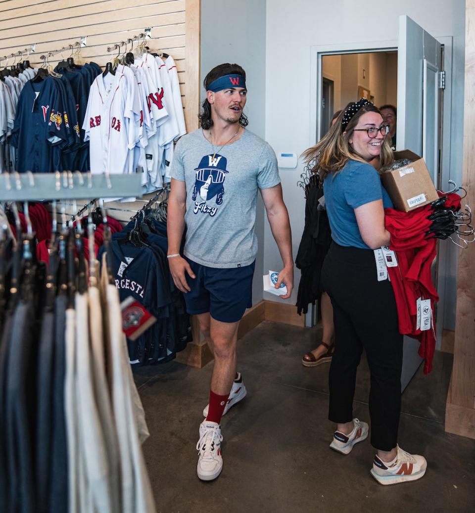 Ryan Fitzgerald, complete with a Fitzy T-shirt, pops into the WooSox Pro Shop before signing autographs Saturday afternoon.