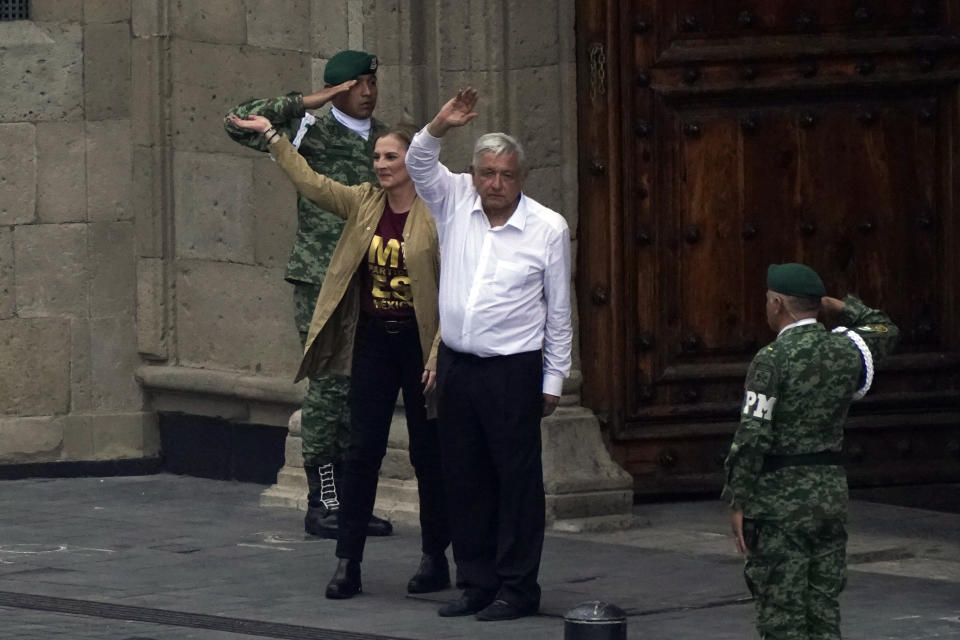 Mexican President Andres Manuel Lopez Obrador and his wife Beatriz Gutierrez say farewell after a march to the capital's main square, the Zócalo, where thousands met to show their support for his government, in Mexico City, Sunday, Nov. 27, 2022. (AP Photo/Marco Ugarte)