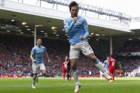 Manchester City's David Silva celebrates after scoring his second goal against Liverpool during their English Premier League soccer match at Anfield Stadium, Liverpool, England, Sunday April 13, 2014. (AP Photo/Jon Super)