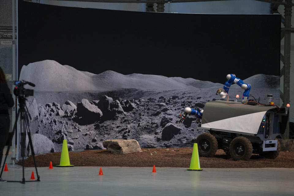 The Space Rover picks up a rock during a training exercise of the European Space Agency, ESA, in Katwijk, near The Hague, Netherlands, Monday, Nov. 25, 2019. (AP Photo/Peter Dejong)