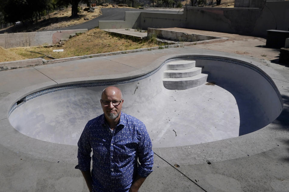 Will Abrams stands for a photo in front of the swimming pool on the lot of his family home that was destroyed by wildfires in 2017 while interviewed in Santa Rosa, Calif., Thursday, June 24, 2021. “I have been really disappointed," Abrams said. “The bankruptcy was sold as something that was going to hold PG&E to account, and it was not. Bankruptcy is not a process to reorganize. It is a process to divide up the dollars." (AP Photo/Jeff Chiu)