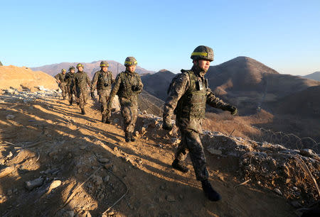 South Korean army soldiers leave for the North to inspect the dismantled North Korean guard post in the central section of the inter-Korean border in Cheorwon, Korea, December 12, 2018. Ahn Young-joon/Pool via REUTERS