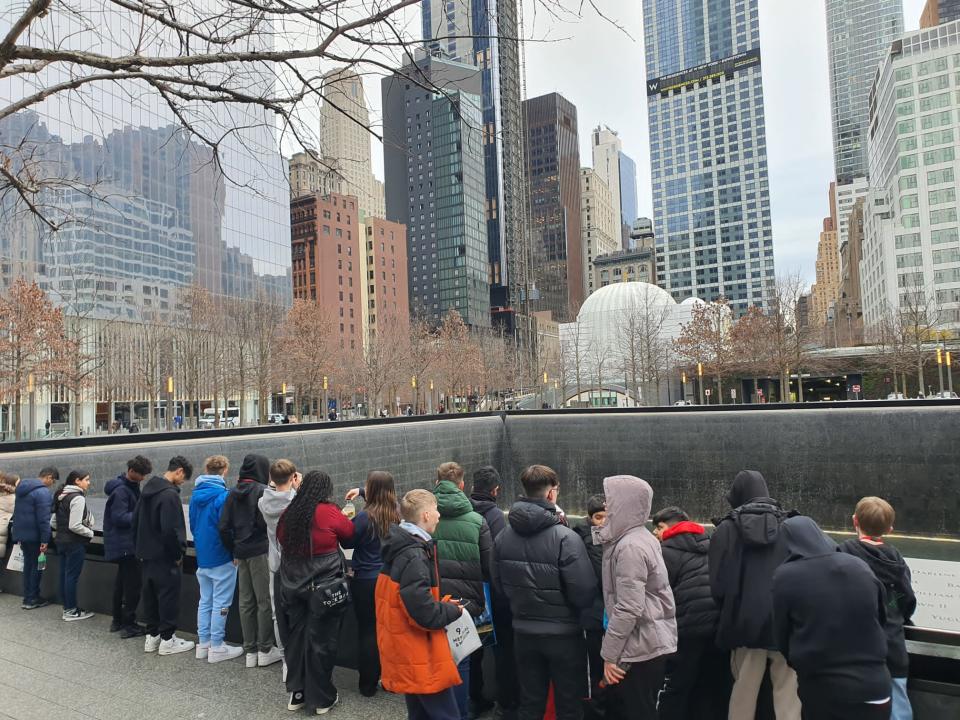 Students lined up in front of the 9/11 Memorial in NYC