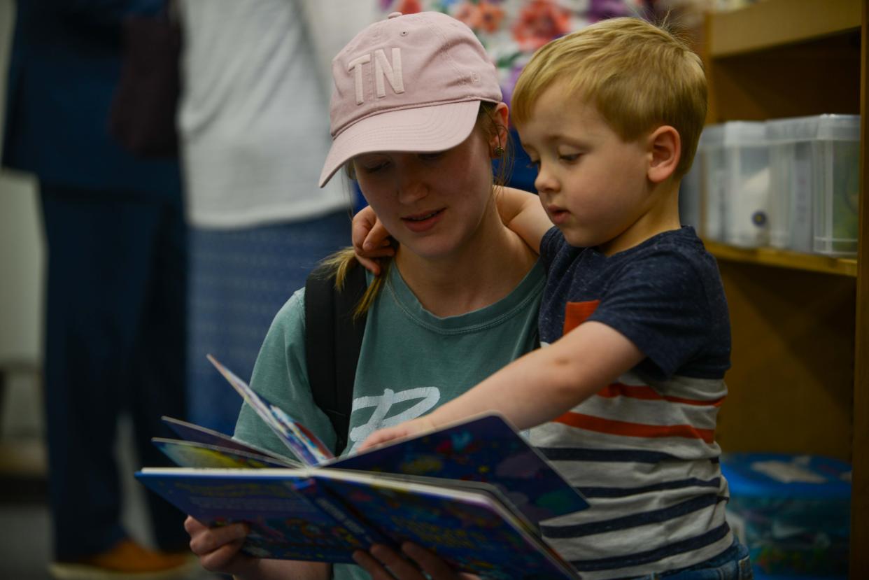 Summer Gilbreath reads to Bear Gilbreath during the Grand Re-Opening of Chester County Library in Henderson, Tenn., on Tuesday, April 30, 2024.