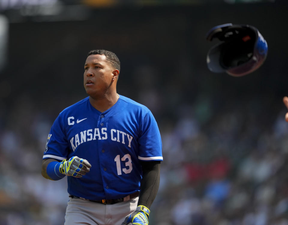 Kansas City Royals' Salvador Perez tosses his helmet to a staff member after striking out against the Seattle Mariners during the first inning of a baseball game Saturday, Aug. 26, 2023, in Seattle. (AP Photo/Lindsey Wasson)