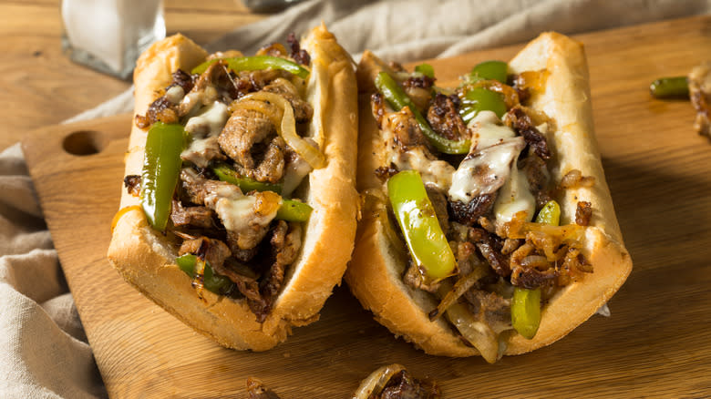 two philly cheesesteaks with peppers