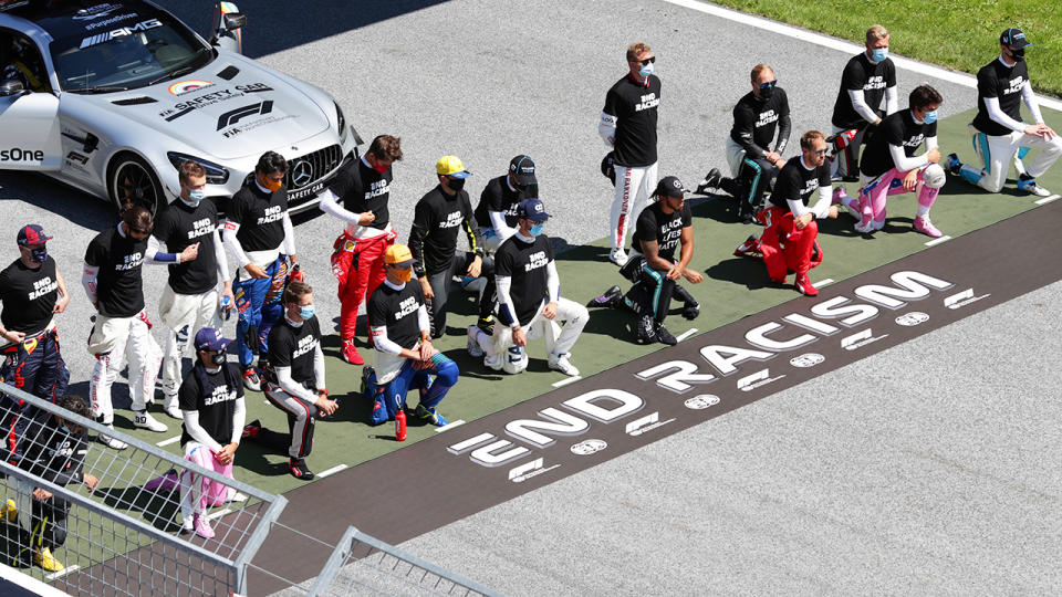 F1 drivers, pictured here taking a knee on the grid in support of the Black Lives Matter movement.