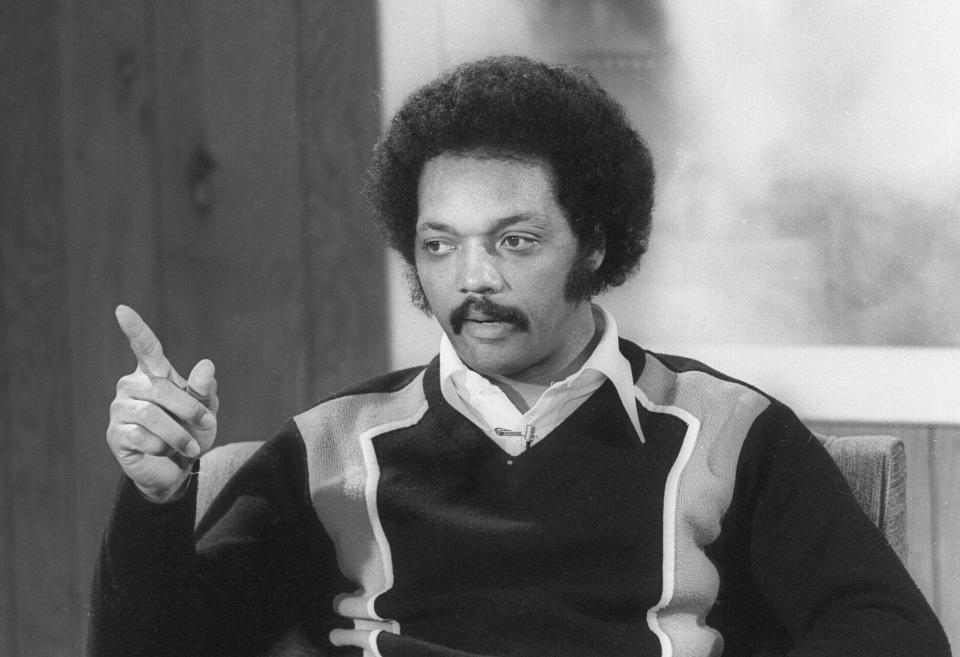 Jesse Jackson, a Babtist Minister and civil rights leader points his finger