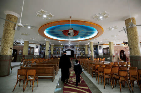 A Christian boy walks with a priest who left with his family from Al-Arish city North Sinai’s Governorate capital after the escalation of a campaign targeting Christians by Islamic State militants last week, walks inside the Saint Church in Ismailia, northeast of Cairo, Egypt February 27, 2017. Picture taken February 27, 2017. REUTERS/Amr Abdallah Dalsh