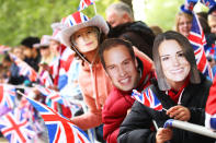 LONDON, ENGLAND - APRIL 29: Well wishers line the route wearing face masks ahead of the Royal Wedding of Prince William to Catherine Middleton at Westminster Abbey on April 29, 2011 in London, England. The marriage of the second in line to the British throne is to be led by the Archbishop of Canterbury and will be attended by 1900 guests, including foreign Royal family members and heads of state. Thousands of well-wishers from around the world have also flocked to London to witness the spectacle and pageantry of the Royal Wedding. (Photo by Julian Finney/Getty Images)