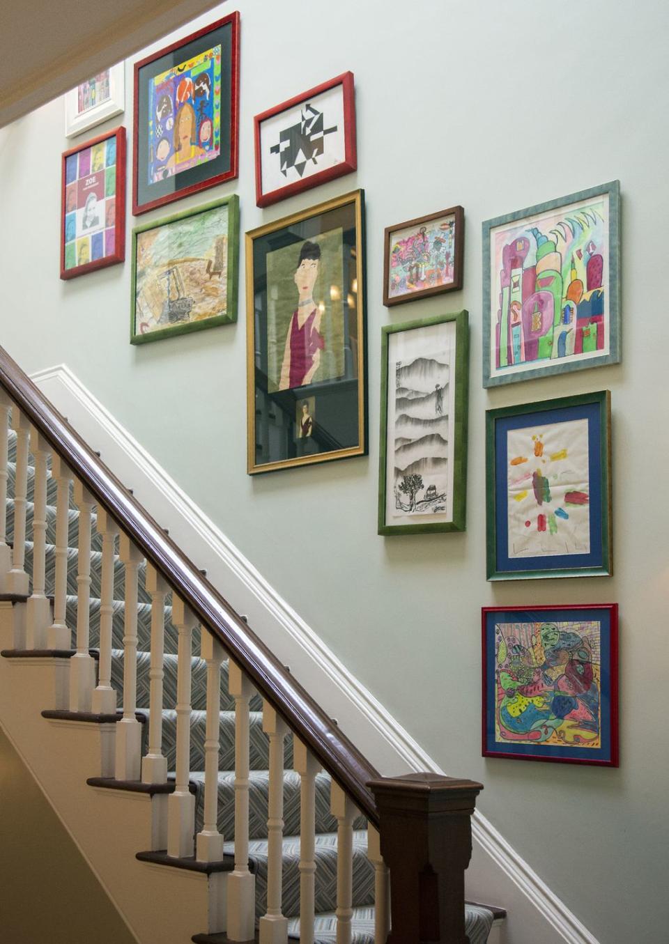 A children's gallery wall along a staircase