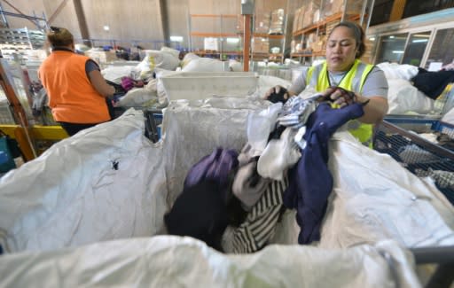 Workers sort clothing at the St Vincent de Paul Society recycling charity in Sydney