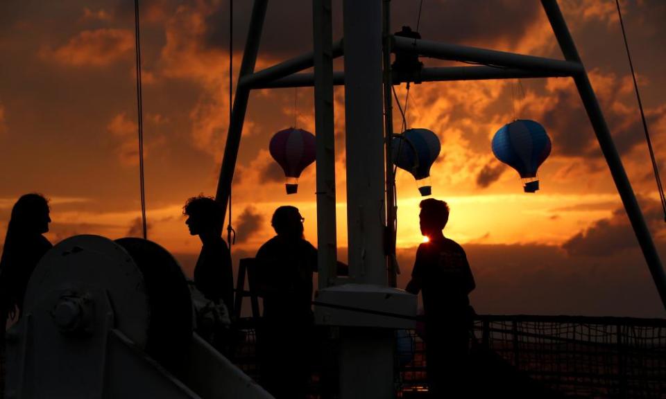 Crew members of the Alan Kurdi rescue ship prepare for a memorial service