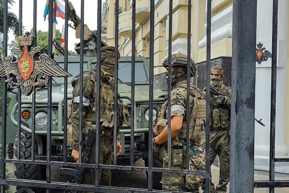 Servicemen of the Wagner Group military company guard an area at the headquarters of the Southern Military District in Rostov-on-Don, Russia, Saturday, June 24, 2023.