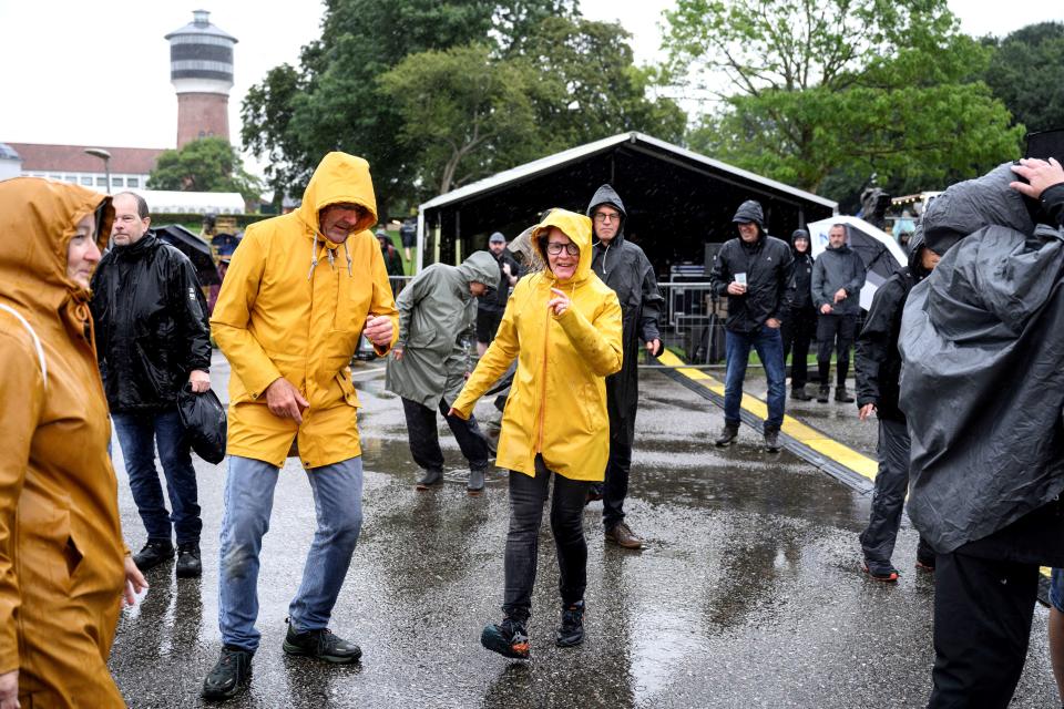 Festival-goers dance at the Toender Festival of folk music during rain as Storm Lilian approaches Jutland, Denmark (Ritzau Scanpix/AFP via Getty Ima)