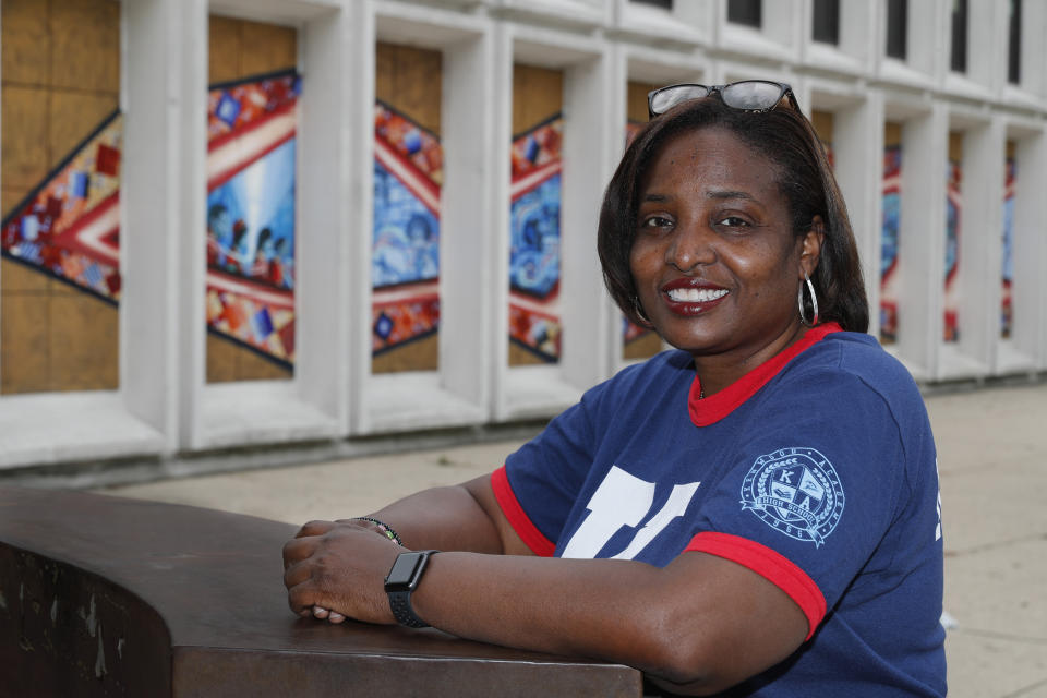 Karen Calloway, principal of Kenwood Academy in Chicago, poses Tuesday, July 28, 2020, for a portrait outside the Hyde Park neighborhood campus. School districts around the U.S. are working to remove police officers from campuses, but the school council for Kenwood Academy, a predominantly Black school near the University of Chicago, recently unanimously voted to keep its officer. (AP Photo/Charles Rex Arbogast)